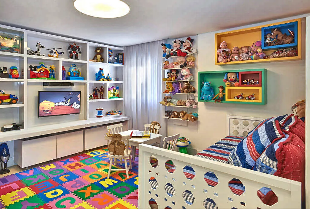 Toy-display wall unit with mismatched licensed toy figures, a TV, an alphabet foam play-mat