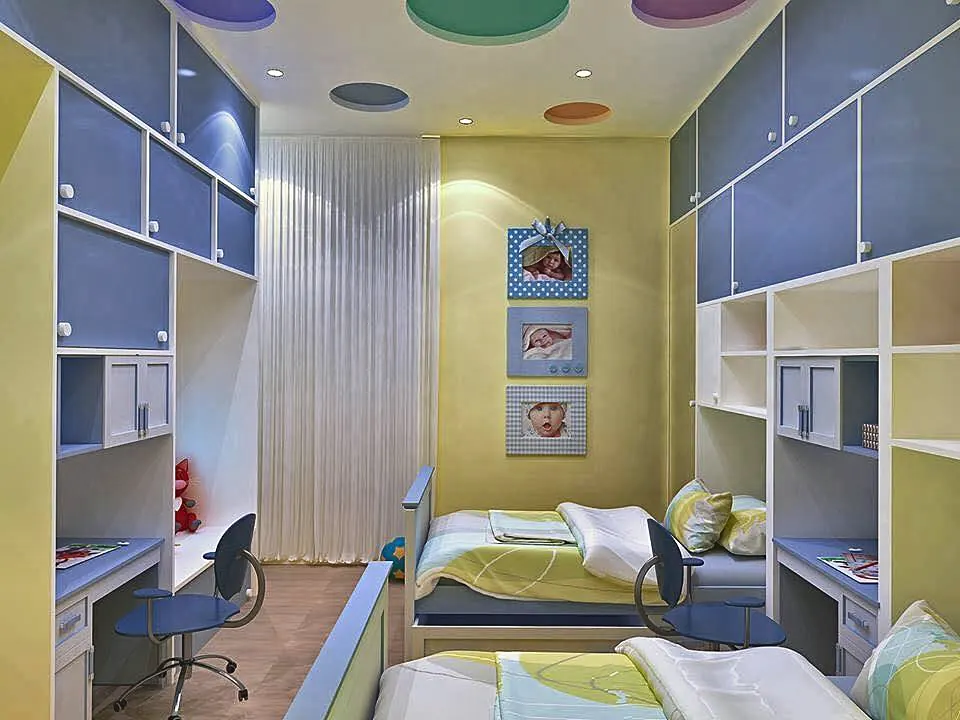 Blue and yellow twin-bed sibling room with colored ceiling roundels and baby photo frames