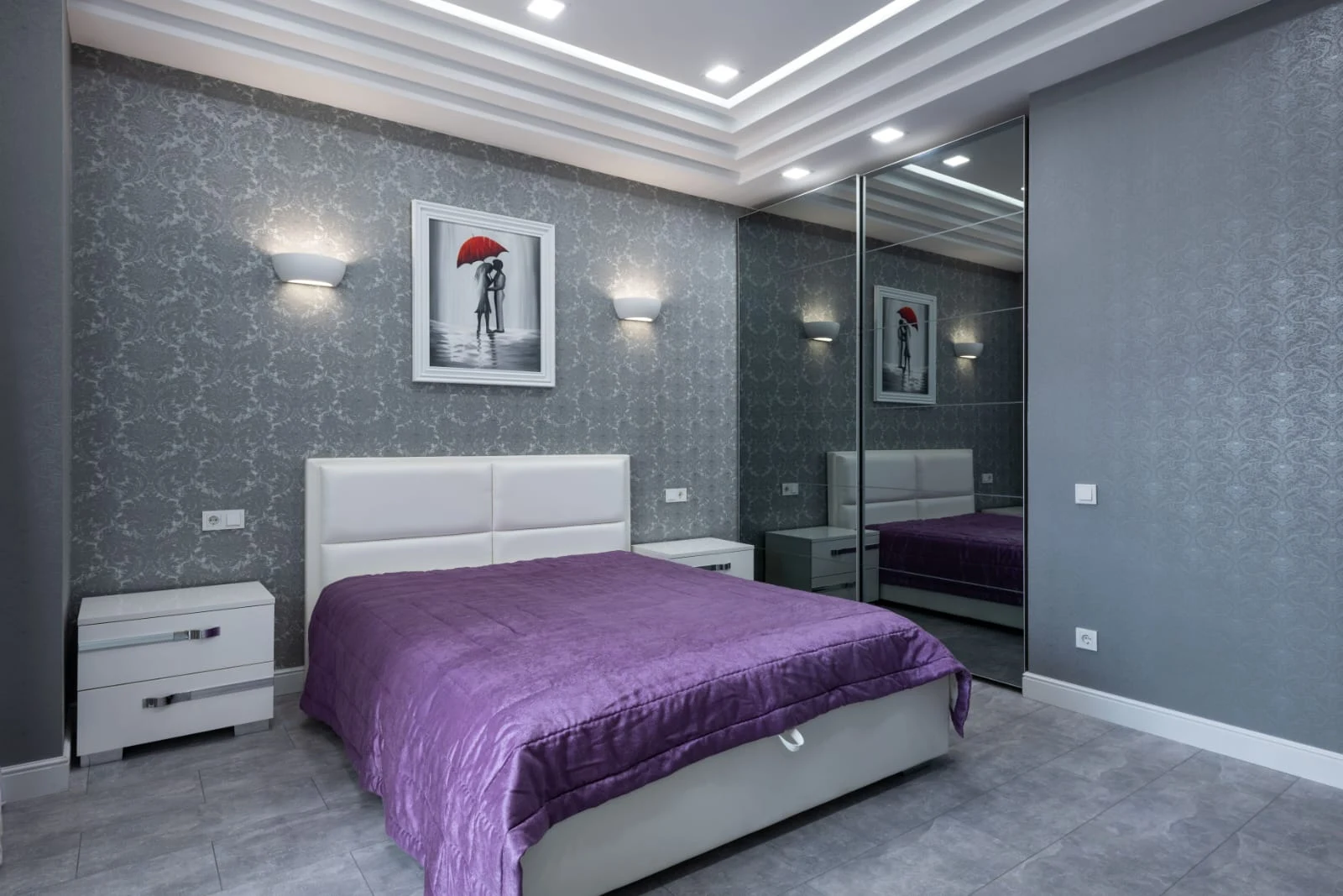 Bedroom wardrobe in a mirrored sliding-door finish against a patterned wallpaper accent wall